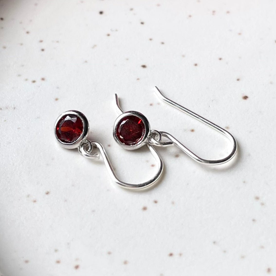 January birthstone earrings. Dainty silver drops of garnet red. Whitby, Ontario